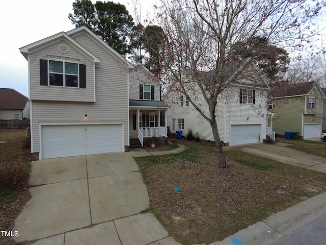 traditional home featuring covered porch, driveway, and a garage