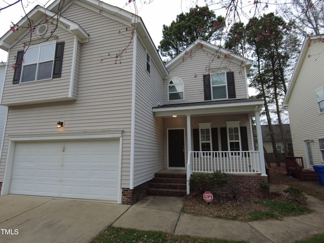 traditional-style house featuring an attached garage, covered porch, and driveway