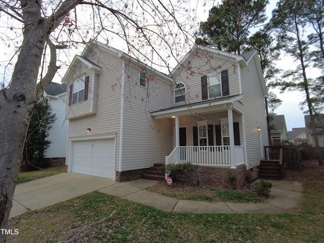 traditional-style home featuring a garage, a porch, and concrete driveway