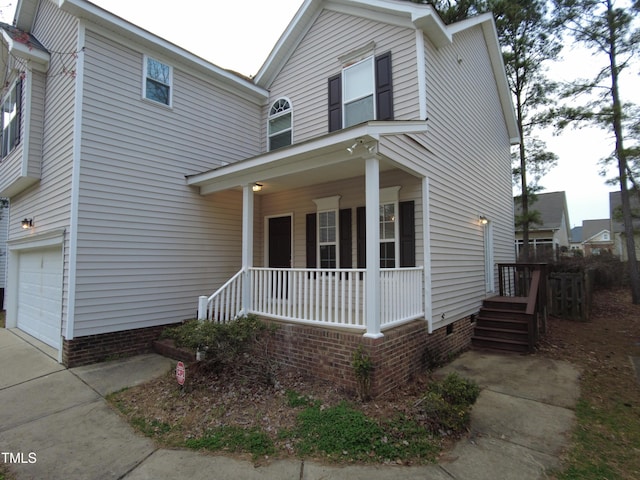 traditional home with a porch and an attached garage