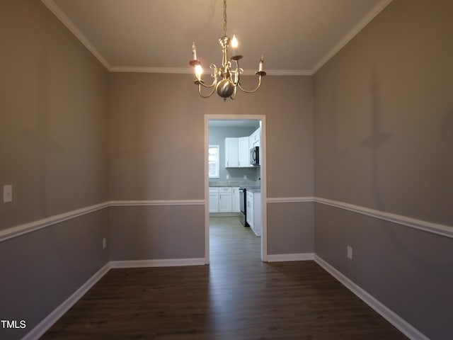 unfurnished dining area with a chandelier, dark wood-type flooring, baseboards, and ornamental molding