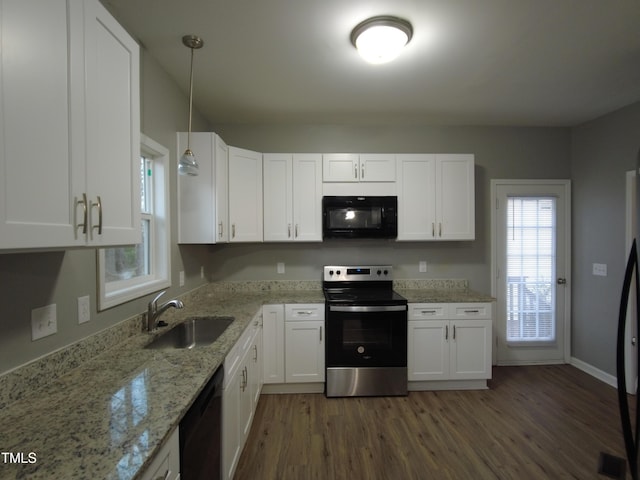 kitchen featuring black appliances, a sink, light stone counters, wood finished floors, and white cabinets