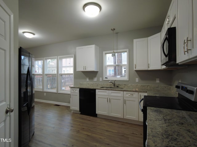 kitchen with black appliances, dark wood-type flooring, light stone countertops, white cabinetry, and a sink