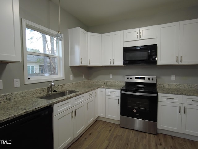 kitchen with a sink, black appliances, wood finished floors, and white cabinetry