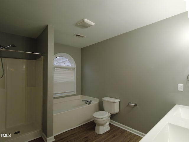 full bathroom featuring a bath, wood finished floors, baseboards, a shower, and toilet