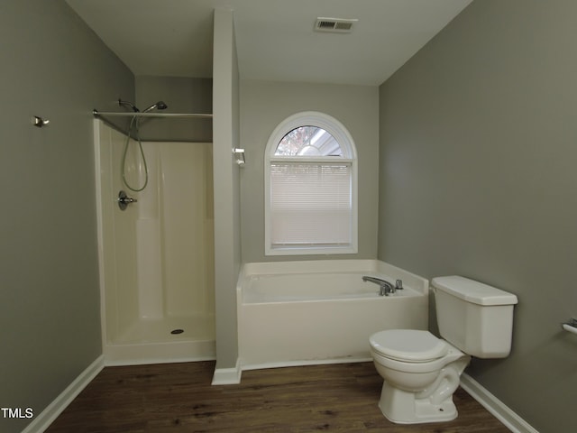 full bathroom with visible vents, toilet, walk in shower, and wood finished floors