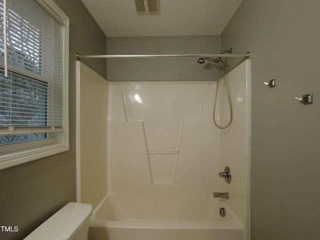 bathroom featuring visible vents, shower / tub combination, and toilet