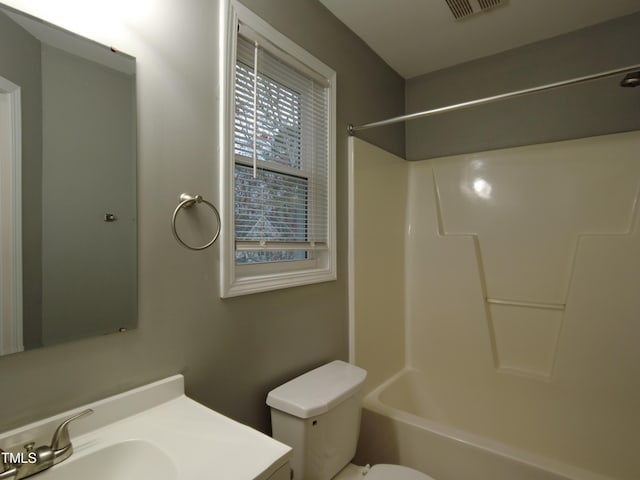 full bathroom with vanity, toilet, visible vents, and shower / washtub combination