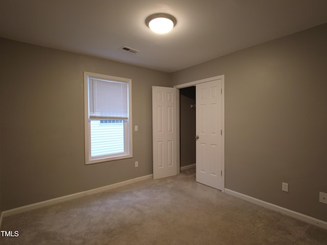 unfurnished bedroom featuring a closet, visible vents, carpet flooring, and baseboards