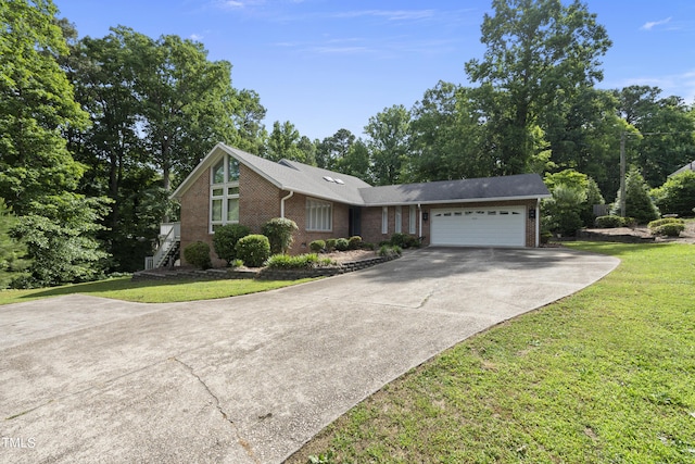 view of front of house with a garage, brick siding, concrete driveway, and a front lawn