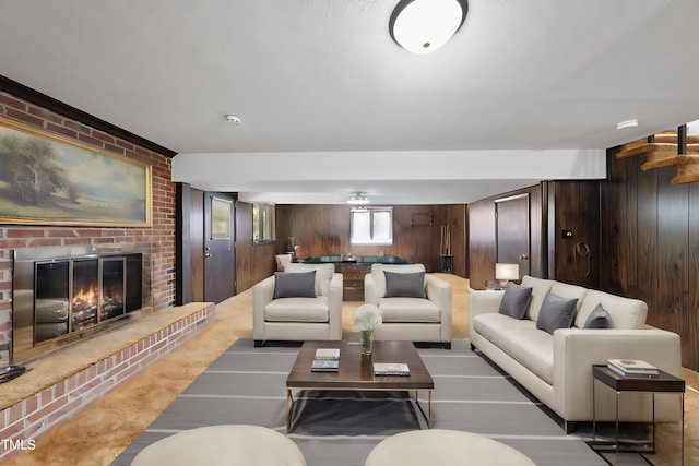 living room featuring wooden walls, a fireplace, and carpet