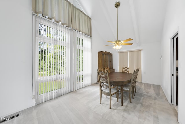 dining area featuring a ceiling fan, beamed ceiling, light colored carpet, and visible vents