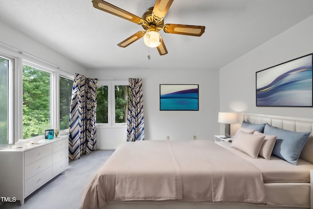 bedroom with a ceiling fan and carpet floors