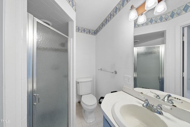 bathroom with vanity, tile patterned floors, toilet, and a stall shower