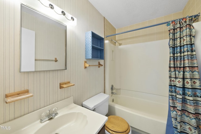 bathroom with vanity, toilet, shower / bath combo, and a textured ceiling