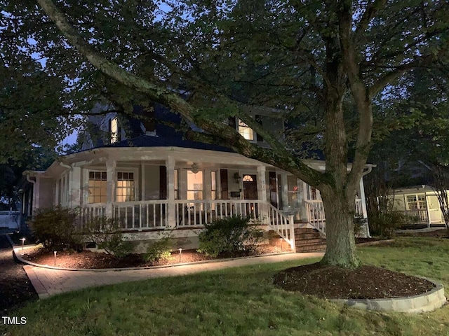 view of front of house with a porch and a front yard