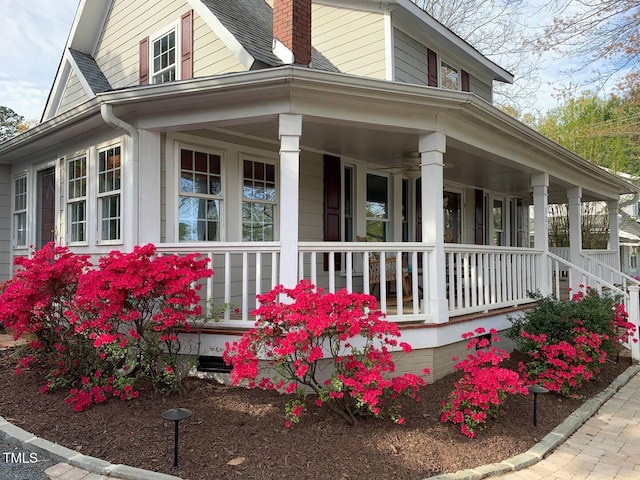 view of property exterior featuring a porch and a chimney