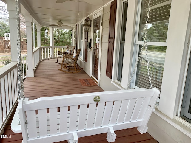 deck featuring a porch and ceiling fan