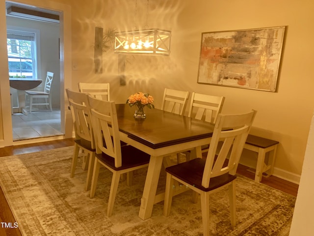 dining space featuring wood finished floors and baseboards