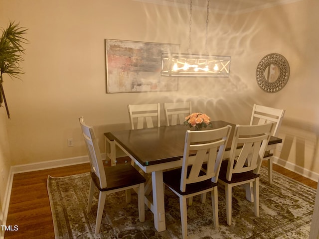 dining room with baseboards and wood finished floors