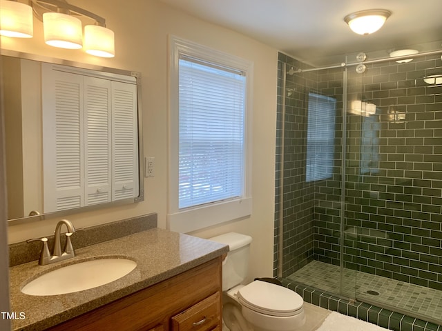 full bath featuring a closet, toilet, a stall shower, and vanity