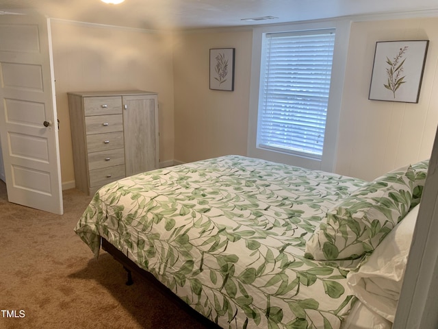 bedroom featuring visible vents and light colored carpet