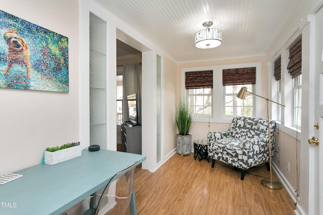 sitting room featuring baseboards and light wood-style floors