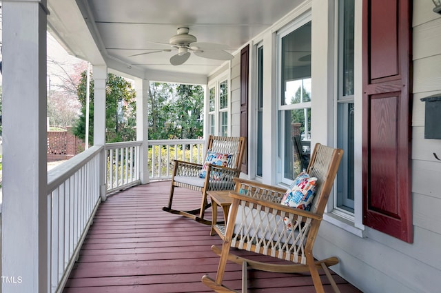 wooden terrace featuring a porch and a ceiling fan