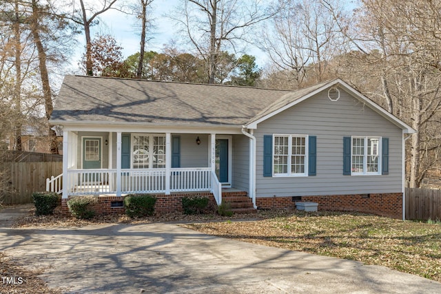 view of front of house featuring covered porch, roof with shingles, crawl space, and fence