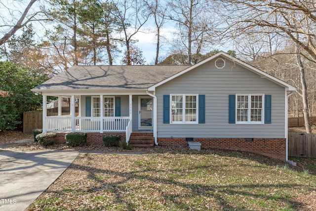 view of front facade with covered porch, fence, roof with shingles, crawl space, and a front yard