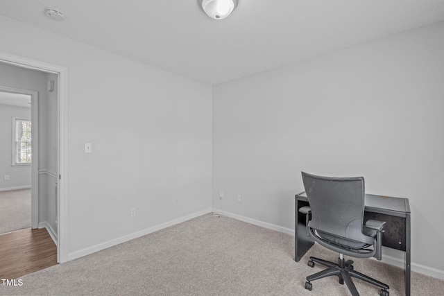 office space featuring carpet floors and baseboards