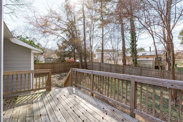 wooden terrace featuring a fenced backyard