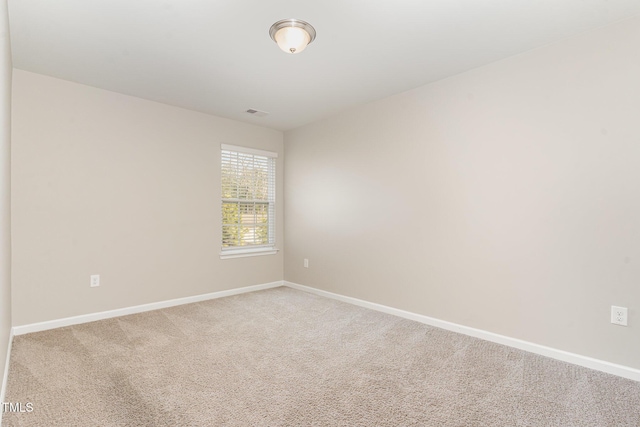 empty room with baseboards and carpet flooring