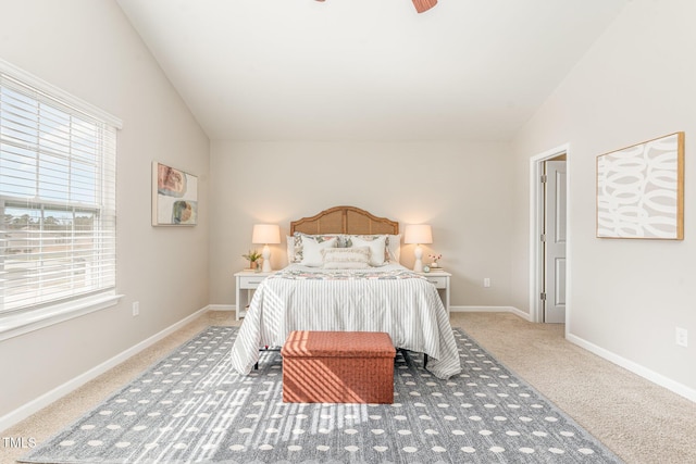 bedroom featuring lofted ceiling, light carpet, and baseboards