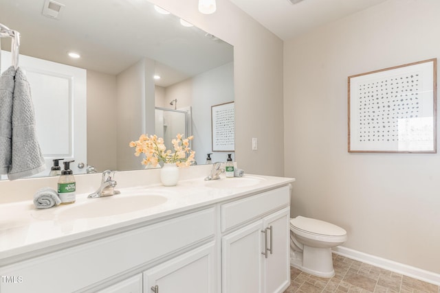 bathroom featuring double vanity, a sink, visible vents, and a shower stall