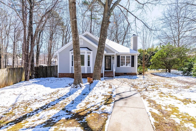 bungalow with crawl space, fence, and a chimney