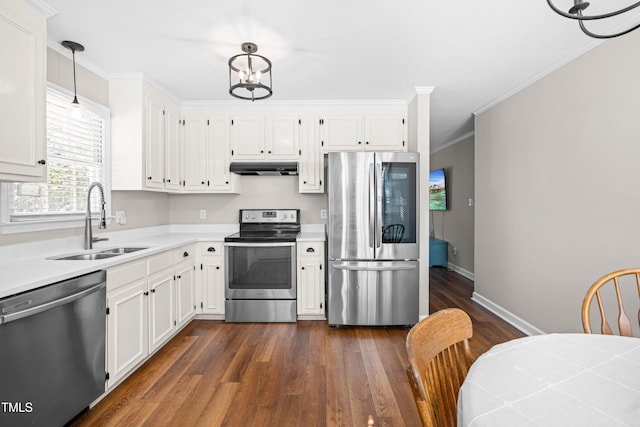 kitchen featuring hanging light fixtures, stainless steel appliances, light countertops, under cabinet range hood, and white cabinetry