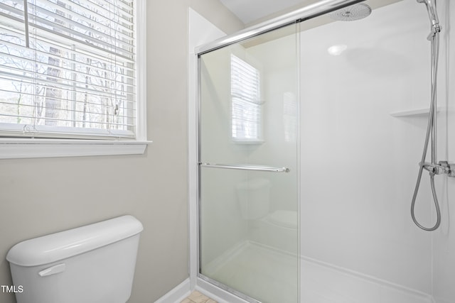 bathroom with a stall shower and toilet