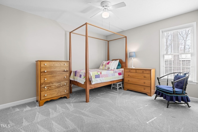 bedroom featuring light carpet, multiple windows, and baseboards