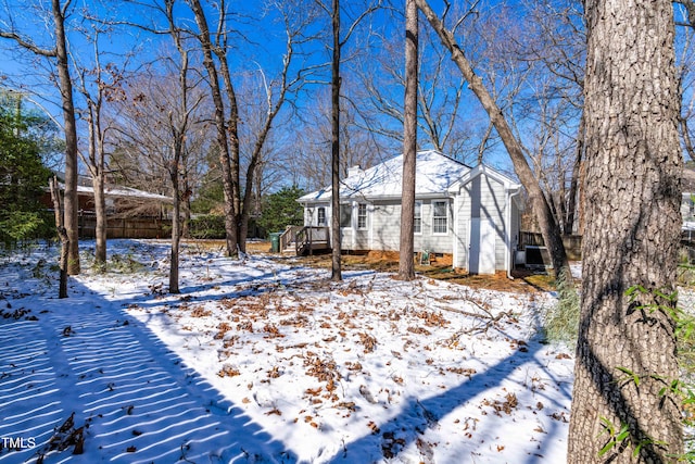 yard covered in snow featuring a deck