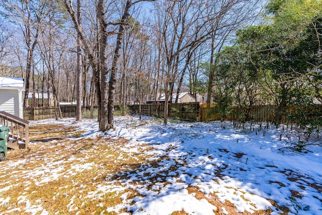 yard covered in snow with fence