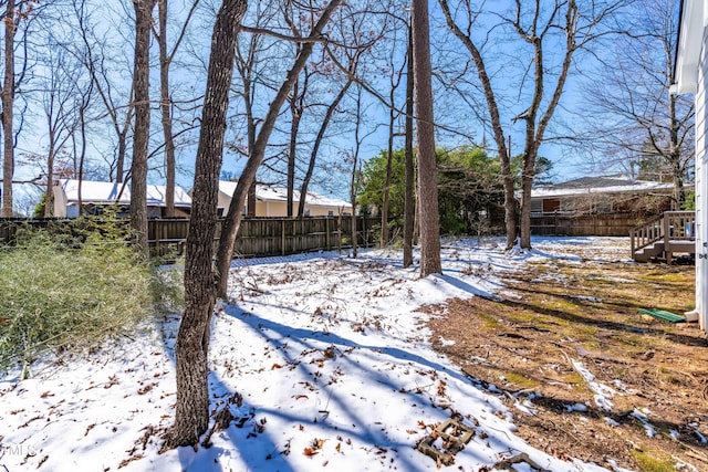 yard covered in snow with fence