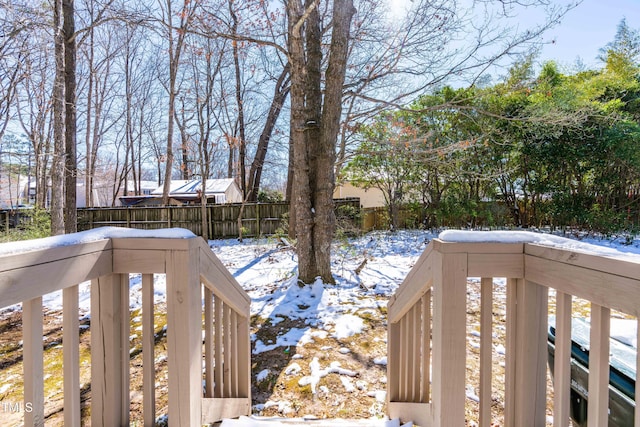 yard layered in snow with fence