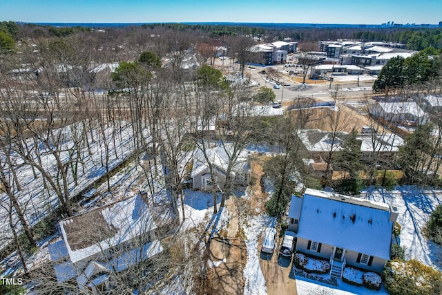 snowy aerial view with a residential view