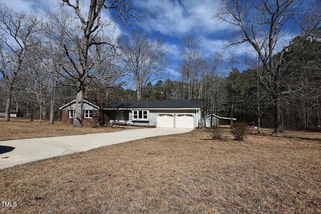 ranch-style house with a garage and concrete driveway