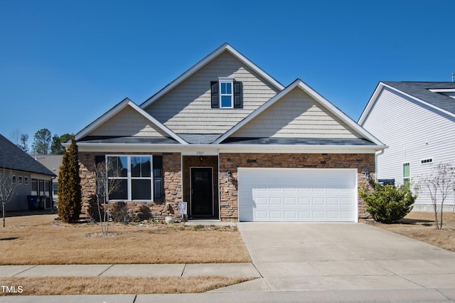 craftsman-style house with concrete driveway and an attached garage