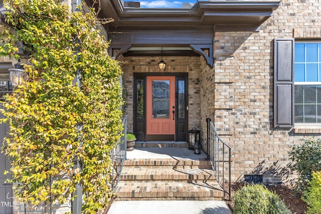 property entrance featuring crawl space and brick siding