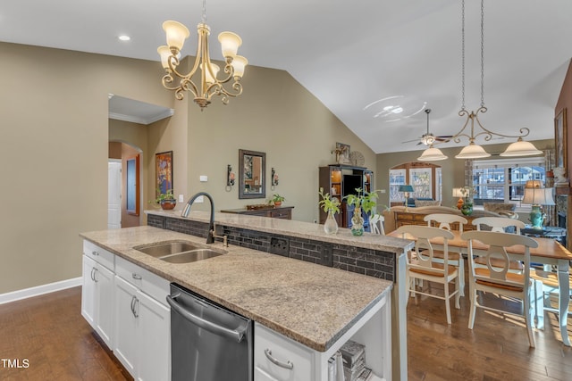 kitchen with arched walkways, open floor plan, a sink, dishwasher, and ceiling fan with notable chandelier