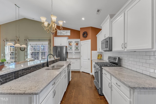 kitchen featuring white cabinets, visible vents, stainless steel appliances, and a sink