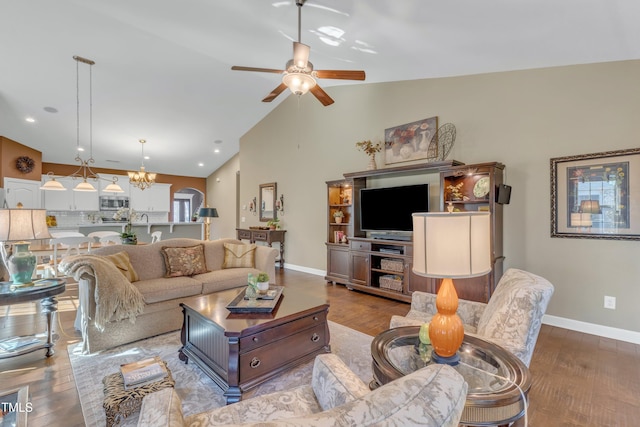 living room featuring ceiling fan with notable chandelier, recessed lighting, wood finished floors, and baseboards